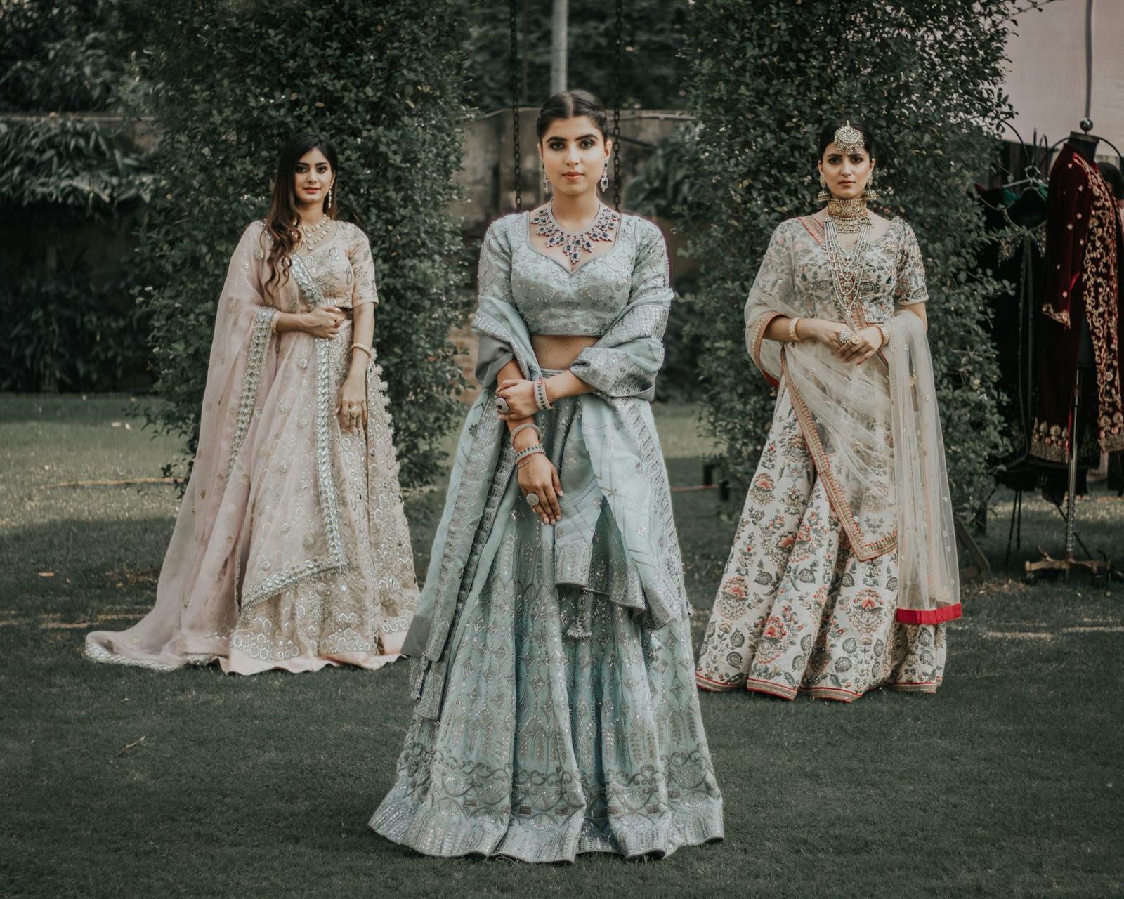 Three bridesmaids in silver and ivory lehengas