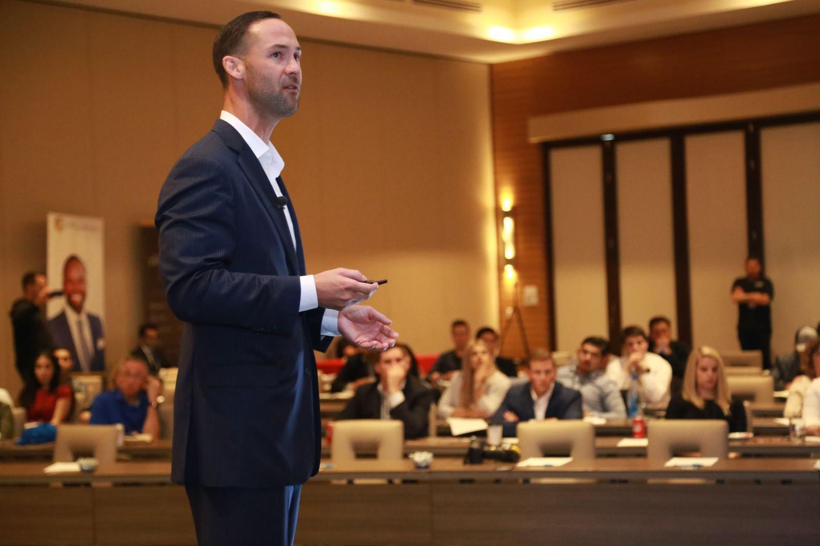 Speaker presenting on stage at a conference