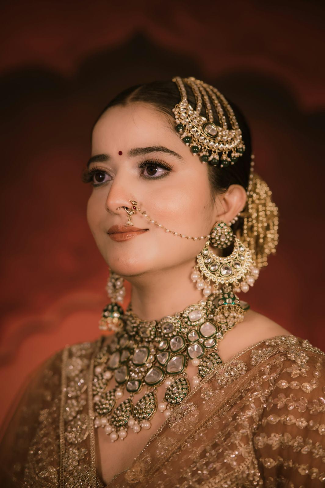 Bride in a gold lehenga and kundan jewellery, close portrait