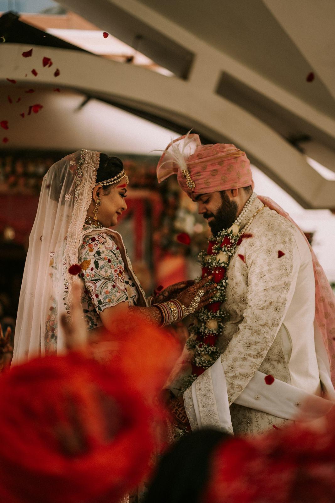 Bride and groom exchanging garlands during the wedding