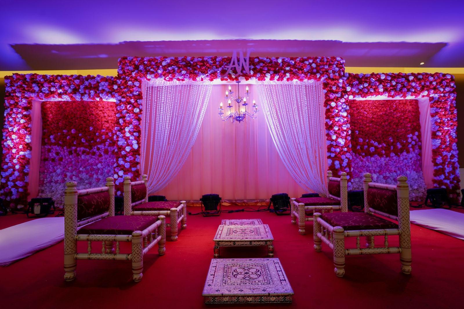 Reception stage decorated in pink and white flowers