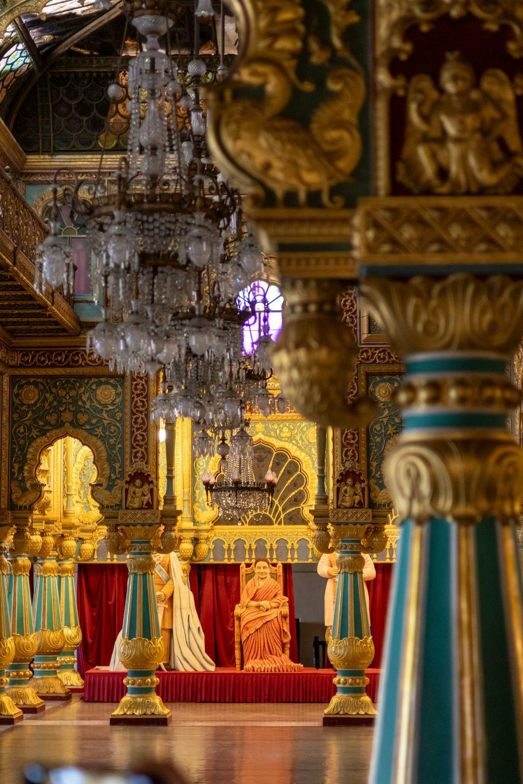 Ornate palace hall with chandeliers and gilded columns
